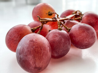Red grapes berries on the white background. Bunch of grape.	
