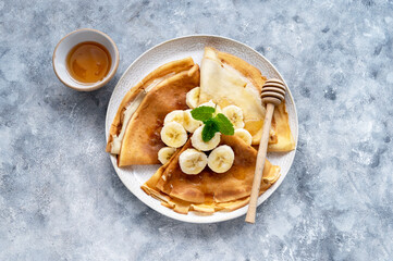 Breakfast with freshly baked cepes or thin pancakes, served with honey and cup of tea.