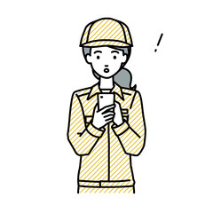 立ってスマートフォンを操作して何かに気づいて驚いた作業員の女性