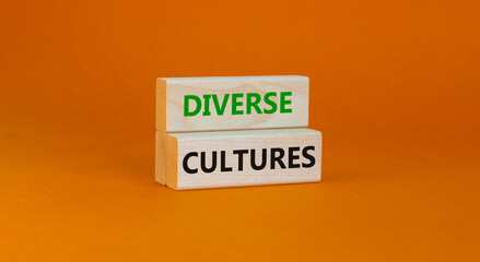 Time to diverse cultures symbol. Wooden blocks with words 'Diverse cultures'. Beautiful orange background. Business and diverse cultures concept. Copy space.