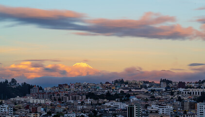 Fototapeta na wymiar Long exposure cityscape of Quito at sunset with Cayambe volcano, Ecuador.