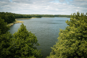 Aerial view of green islands and clouds at summer sunny day. Masurian Lake District in Poland. 