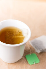 cup of tea with a green tea bag label, closeup view with copy space, mock-up template