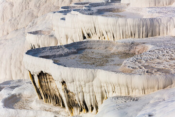 Fototapeta na wymiar Amazing landscape of Pamukkale thermal springs with cascade of white calcite terraced baths, Turkey
