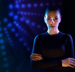 Concept of future technology or entertainment system, virtual reality. Female portrait lit by HUD interface