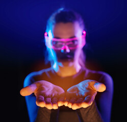 Concept of future technology or entertainment system, virtual reality. Female portrait lit by HUD...