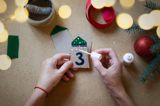 Christmas advent calendar with gifts for children. DIY instruction, step by step. Selective focus, warm vintage toning