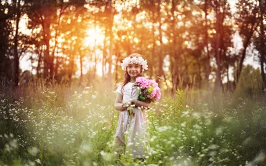 Schilderijen op glas Portrait of cute kid girl with bloom flowers. Nature outdoor. Child in nature concept. © konradbak