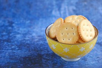 cracker or biscuits stack served in a bowl on background isolated.
