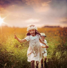Poster Cute siblings on a summer meadow © konradbak