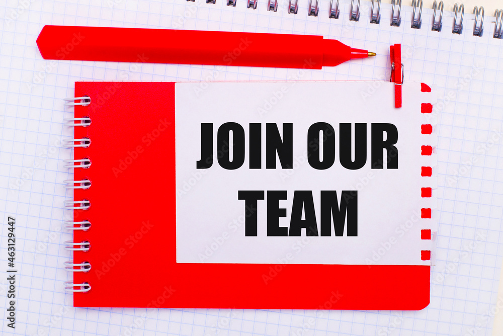 Poster on a white notepad, a red pen, a red notepad and a white sheet of paper with the text join our team