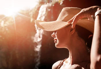 Tuinposter Happy young woman with straw hat enjoying her summer holidays © konradbak