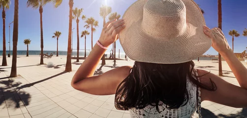 Foto op Plexiglas Happy young woman with straw hat enjoying her summer holidays © konradbak