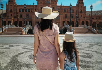 Rolgordijnen Loving mother and her cute daughter exploring city on a sunny summer day. © konradbak
