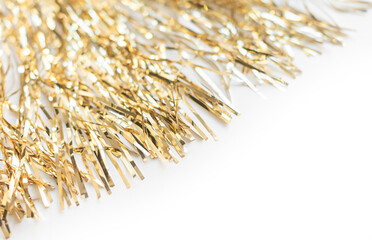 Golden tinsel on a white background. Christmas and New Year holiday concept