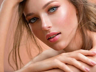 Beautiful white girl with red lips looks to the camera. Stunning blonda girl. Closeup face of young...