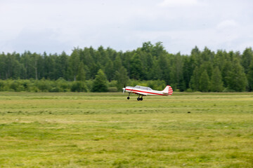 Fototapeta na wymiar Propeller-driven aircraft to land on an unpaved airfield