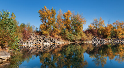 Old flooded quarry in autumn