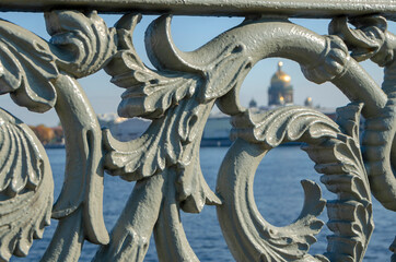 Part of the lattice close-up on the background of St. Isaac's Cathedral on the Lieutenant Schmidt Bridge across the Neva River in St. Petersburg, Russia