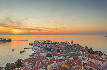Drone panorama of Croatian coastal town Porec with harbor and promenade during sunrise