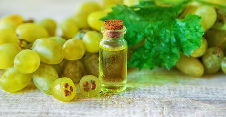 Grape seed oil in a bottle. Selective focus.