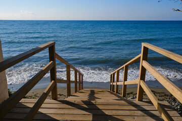 Wooden stairs leading down to the Mediterranean Sea