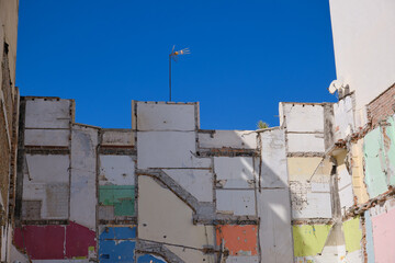 A house destroyed, only traces of paint remain.