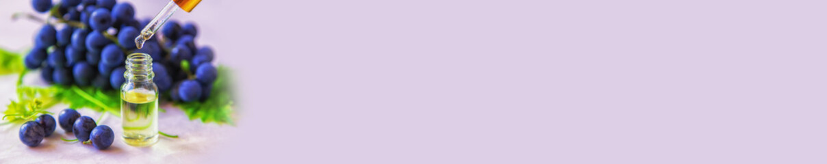 Grape seed oil in a bottle. Selective focus.