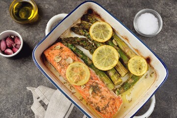 Baked salmon fillet with asparagus, lemon and olive oil. Healthy eating.
