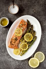 Baked salmon fillet with asparagus, lemon and olive oil. Healthy eating.