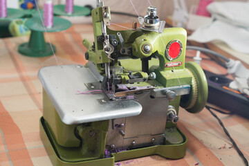 a professional sewing machine with an overlock of the twentieth century. Equipment for edging, hemming or sewing clothes.