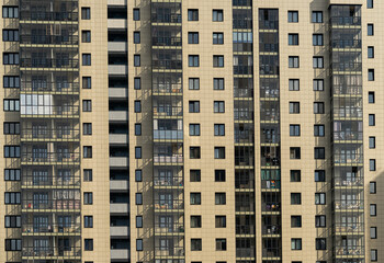 Fototapeta na wymiar Windows of the residential building. Urban obsolete facade of house. The windows of building 
