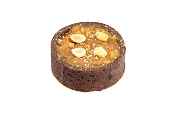 Mini caramel tart with hazelnuts isolated on white