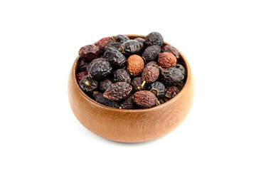 Dried rose hips in wooden bowl isolated on white