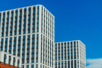 Fototapeta premium Windows of the residential building. Urban obsolete facade of house. The windows of building 