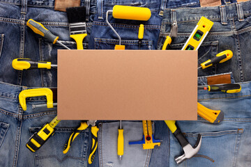 Kit of construction tools with jeans pocket background texture. House renovation concept