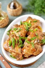 Chicken thighs stewed with onions.