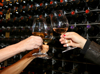 hands holding glasses of wine