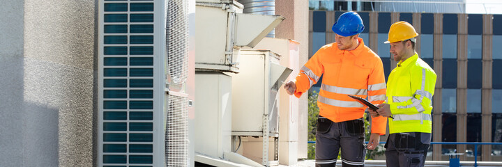 An Electrician Men Checking Air Conditioning Unit