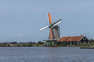 Traditional Dutch old wooden windmill in Zaanse Schans - village in Zaandam. The Netherlands. 