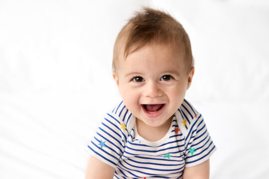 Portrait of cute laughing baby with brown eyes