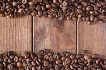 Coffee beans on a wooden surface as a background.