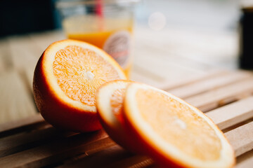 Sliced of fresh orange on a slatted wooden surface