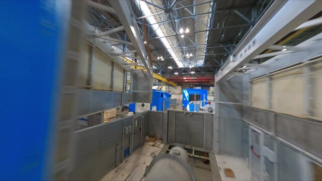 Motion along spacious workshop with huge details of contemporary assembled air compressor at production plant