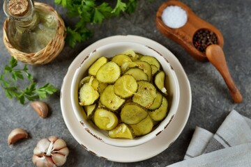Pickled cucumber slices in mustard and coriander seeds.
