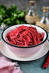 Healthy salad of beets, carrots, onions and garlic with wine vinegar and olive oil.