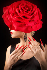 Beauty Fashion Model Woman with red rose flower. Red Lips and Nails. Valentine's Day Beautiful Fashion sexy Girl with flying long hair. Beautiful Sexy Brunette with Luxury Makeup and Manicure