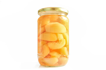 Canned peaches in glass jar isolated on white background. Compote made of sliced fruit halves