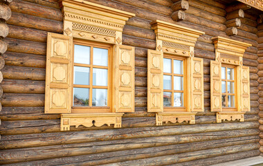 Windows of wooden house decorated with wooden carvings