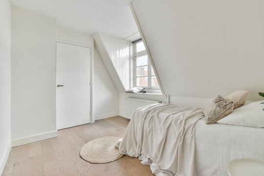 Light bedroom in a mansard of the house